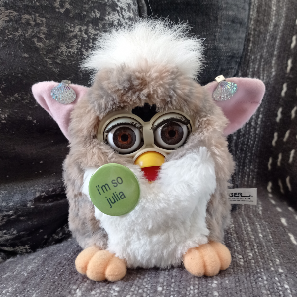 church mouse furby wearing an [I'm So Julia] pin